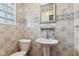 Charming half-bath with pedestal sink, tile backsplash and floors, and modern fixtures at 3638 Redfern Dr, Indianapolis, IN 46237