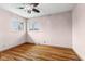 Bedroom featuring hardwood floors, ceiling fan and two windows for natural light at 3638 Redfern Dr, Indianapolis, IN 46237