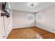 Bright bedroom with hardwood floors, two windows for ample natural light, and ceiling fan at 3638 Redfern Dr, Indianapolis, IN 46237