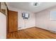 Bedroom showcasing hardwood floors, a mounted TV, and a window for natural light at 3638 Redfern Dr, Indianapolis, IN 46237