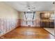 Cozy dining room with hardwood floors, warm wood paneling, and bright window at 3638 Redfern Dr, Indianapolis, IN 46237