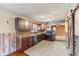 Modern kitchen with dark wood cabinetry, stainless steel appliances, and tiled flooring at 3638 Redfern Dr, Indianapolis, IN 46237