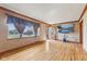 Bright living room with hardwood floors, a large window, and a door leading to the exterior at 3638 Redfern Dr, Indianapolis, IN 46237