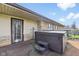 Back patio featuring door to back of house, hot tub, and stone veneer exterior at 3638 Redfern Dr, Indianapolis, IN 46237