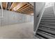 Unfinished basement with concrete floor and stairs at 401 Iowa St, Indianapolis, IN 46225