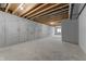 Unfinished basement space with concrete walls and floor offers potential for customization and expansion at 401 Iowa St, Indianapolis, IN 46225