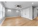 Bright bedroom with wood-look floors, ceiling fan, and plenty of natural light from multiple windows at 401 Iowa St, Indianapolis, IN 46225