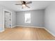 Bedroom with wood flooring, ceiling fan, and bright window at 401 Iowa St, Indianapolis, IN 46225