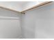 Simple closet with a wooden clothing rack and white interior, ideal for organizing belongings efficiently at 401 Iowa St, Indianapolis, IN 46225