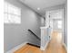Bright hallway features light wood flooring, neutral walls, and natural light from a window at 401 Iowa St, Indianapolis, IN 46225