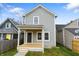 Charming two-story home with a covered front porch and landscaped yard at 401 Iowa St, Indianapolis, IN 46225