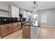 Well-lit kitchen with black countertops, island seating, stainless steel appliances, and floating shelves at 401 Iowa St, Indianapolis, IN 46225