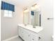 Well-lit bathroom with dual sinks, white cabinetry, and a window with decor at 4179 Hume Ave, Plainfield, IN 46168
