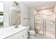 Bathroom featuring a white vanity, a large mirror, and a glass-enclosed shower at 4179 Hume Ave, Plainfield, IN 46168