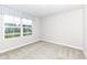 This bedroom features neutral carpeting, white walls and a large window that lets in natural light at 4179 Hume Ave, Plainfield, IN 46168