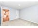 This bedroom features neutral carpeting, white walls and an open door to the kitchen at 4179 Hume Ave, Plainfield, IN 46168