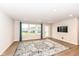 Bright living room with hardwood floors, large windows, and a decorative rug at 4179 Hume Ave, Plainfield, IN 46168
