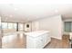 Open concept living room with hardwood floors, large windows, and a decorative rug, creating a welcoming atmosphere at 4179 Hume Ave, Plainfield, IN 46168