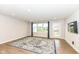 Bright living room with hardwood floors, large windows, and a decorative rug at 4179 Hume Ave, Plainfield, IN 46168
