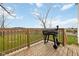Enjoy outdoor cooking on this back deck complete with a wooden railing and grill at 431 W Main St, Lizton, IN 46149