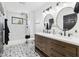 Bright bathroom featuring a double vanity, tiled shower, and patterned floors at 431 W Main St, Lizton, IN 46149