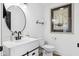 Stylish bathroom featuring modern vanity, round mirror, and contemporary fixtures with ample lighting at 431 W Main St, Lizton, IN 46149