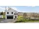 Exterior of a modern farmhouse, with black garage door and nice front yard at 431 W Main St, Lizton, IN 46149