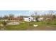Spacious backyard with mature trees and play area at 431 W Main St, Lizton, IN 46149