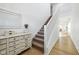 Bright hallway featuring a staircase, white trim, and a decorative console table with elegant decor at 431 W Main St, Lizton, IN 46149