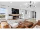 Bright living room with a modern fireplace, recessed lighting, and a comfortable leather couch at 431 W Main St, Lizton, IN 46149