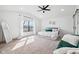 Bright main bedroom with a vaulted ceiling, large window, and plush carpeting, creating a relaxing retreat at 431 W Main St, Lizton, IN 46149