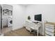 Bright office space with built-in desk with computer, opening to laundry room at 431 W Main St, Lizton, IN 46149
