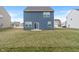The backyard features a green lawn, offering outdoor space and privacy for the home at 432 Bluestem Ln, Whiteland, IN 46184