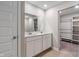Well-lit bathroom with double sink vanity and a separate closet or dressing area at 432 Bluestem Ln, Whiteland, IN 46184