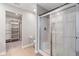 Bathroom featuring a glass-door shower, light-colored tiling and a closet room with shelving at 432 Bluestem Ln, Whiteland, IN 46184