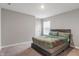 Bedroom featuring a large window, carpet floors and a gray bed with a decorative headboard at 432 Bluestem Ln, Whiteland, IN 46184