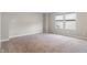 Bright, carpeted bedroom with a large window, neutral walls, and ample natural light at 432 Bluestem Ln, Whiteland, IN 46184