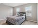 Bedroom with two large windows, carpet floors and a gray bed with a decorative headboard at 432 Bluestem Ln, Whiteland, IN 46184
