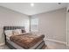 Bedroom featuring a large window, carpet floors and a gray bed with a decorative headboard at 432 Bluestem Ln, Whiteland, IN 46184