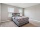 Bedroom with two large windows, carpet floors and a gray bed with a decorative headboard at 432 Bluestem Ln, Whiteland, IN 46184