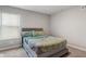 Bedroom featuring a large window, carpet floors and a gray bed with a decorative headboard at 432 Bluestem Ln, Whiteland, IN 46184