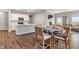 Open-concept dining area featuring a modern table set and seamless flow to the kitchen at 432 Bluestem Ln, Whiteland, IN 46184