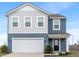 Charming two-story home with blue and gray siding, white trim, and attached two car garage at 432 Bluestem Ln, Whiteland, IN 46184