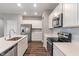 Well-equipped kitchen with stainless steel appliances, white cabinets and an island with a sink at 432 Bluestem Ln, Whiteland, IN 46184