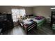 Bright bedroom with hardwood floors, a large window, and two beds at 4320 Lucky Ct, Indianapolis, IN 46203