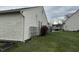 Shows the house's exterior, highlighting the siding and surrounding lawn at 4320 Lucky Ct, Indianapolis, IN 46203