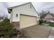 Two-car garage featuring a large door, brick accents, and exterior lighting, offering ample parking at 4320 Lucky Ct, Indianapolis, IN 46203
