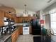 Efficient kitchen with stainless appliances and black refrigerator with room for storage above the cabinets at 4320 Lucky Ct, Indianapolis, IN 46203