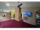 Spacious living room features a ceiling fan, television, and open access to other rooms at 4320 Lucky Ct, Indianapolis, IN 46203