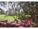 Relaxing backyard hammock provides a peaceful retreat amidst lush greenery and mature trees at 5139 Kingswood Dr, Carmel, IN 46033